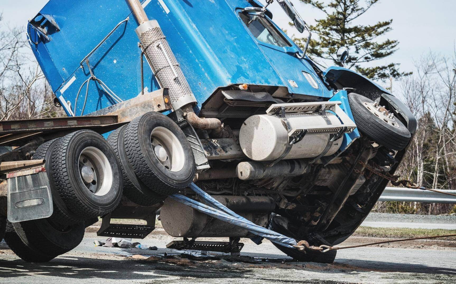 A truck tipping over after an accident from negligent driving in Brookhaven, Georgia