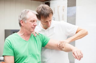 Chiropractic Doctor Adjusts Man's Shoulder