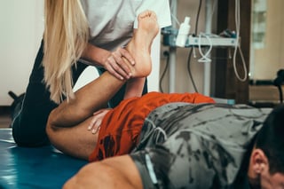 Doctor Adjusting Man's Leg After an Accident Injury