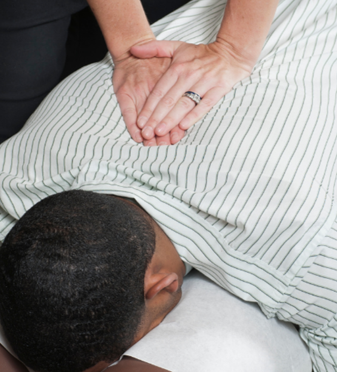 chiropractor adjusting mans spine